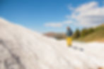 A man skiing down a snowy mountain in his insulated apparel