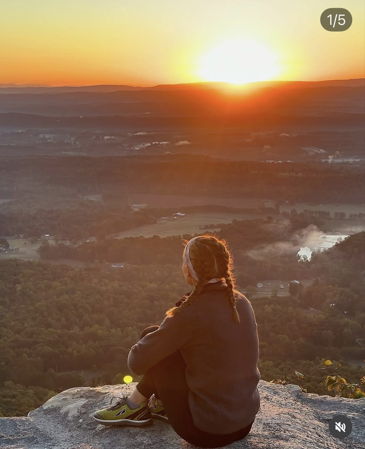 Erin watching a sunrise from a mountain overlook