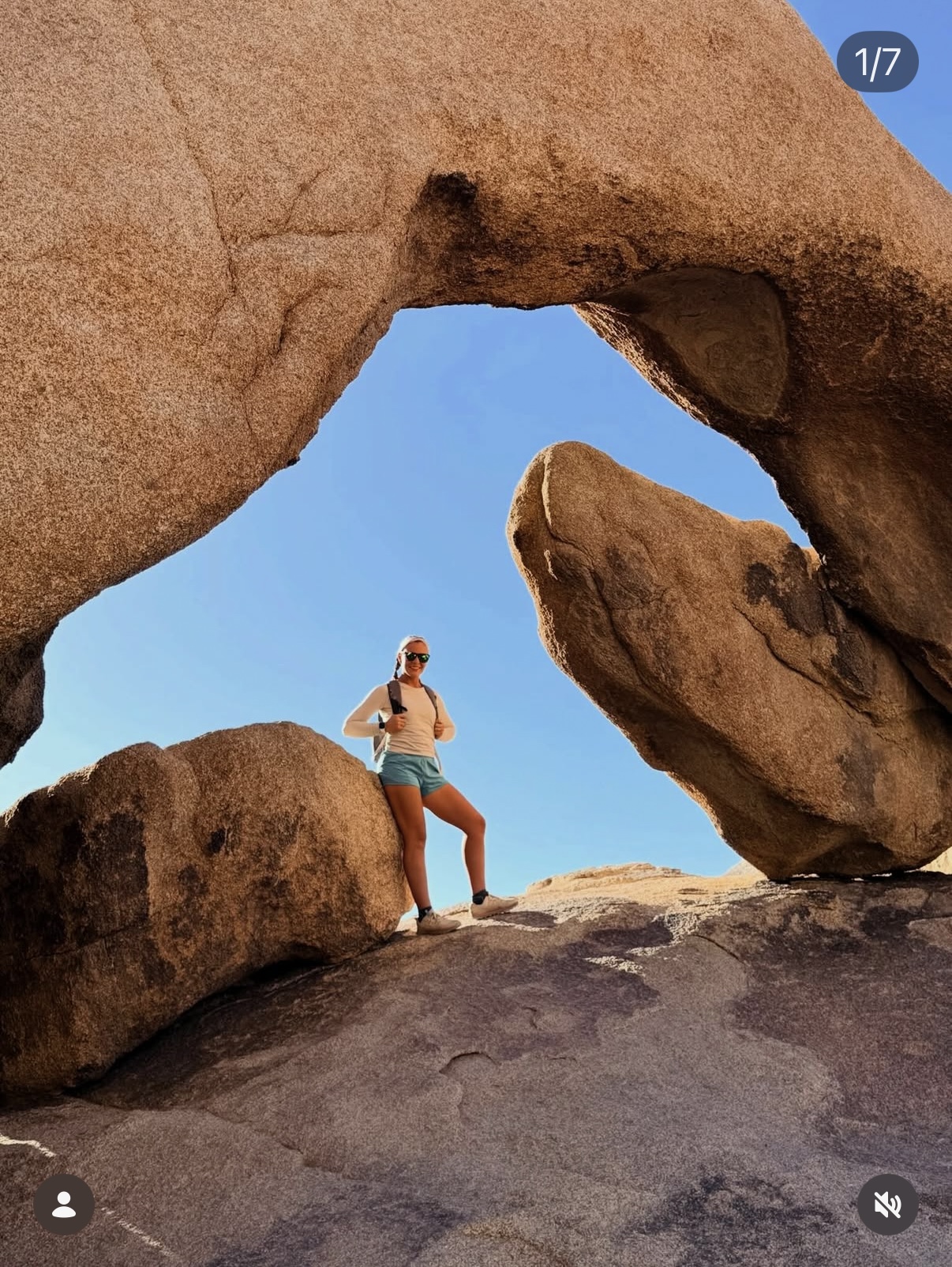 Erin standing beneath a natural rock arch