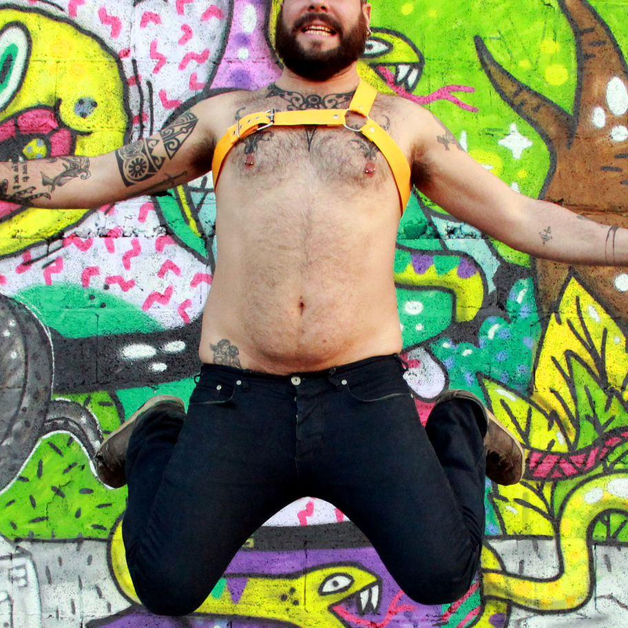 man jumping with yellow harness