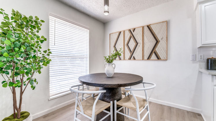 Explore the sophistication of our apartment model unit staging, highlighting an elegant dining room by Chic Designs. Immerse yourself in the perfect blend of modern aesthetics, functional design, and stylish furnishings, creating a captivating space for potential residents.