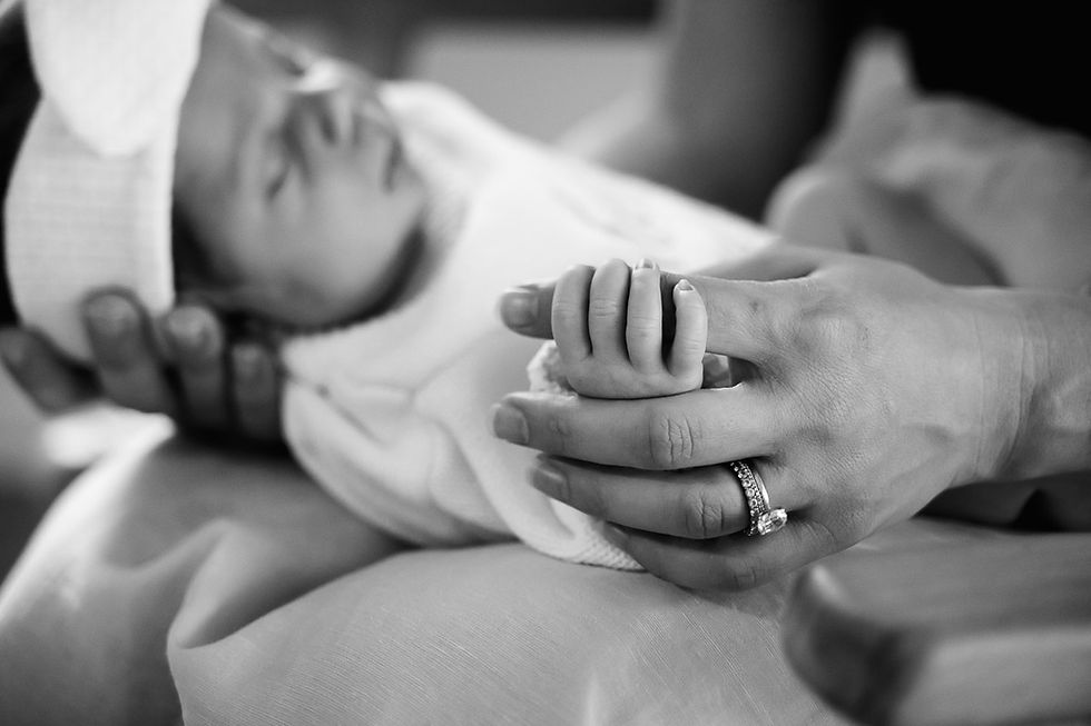 newborn baby tiny fingers clasping mothers hand during newborn in home photography session on the Gold Coast