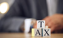 Business person, hands and blocks for tax, financial advisor or accounting on office desk 