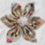 Gray collar flower with a pattern of red and black dogs and and text saying I Wuff You set against a gray textured background