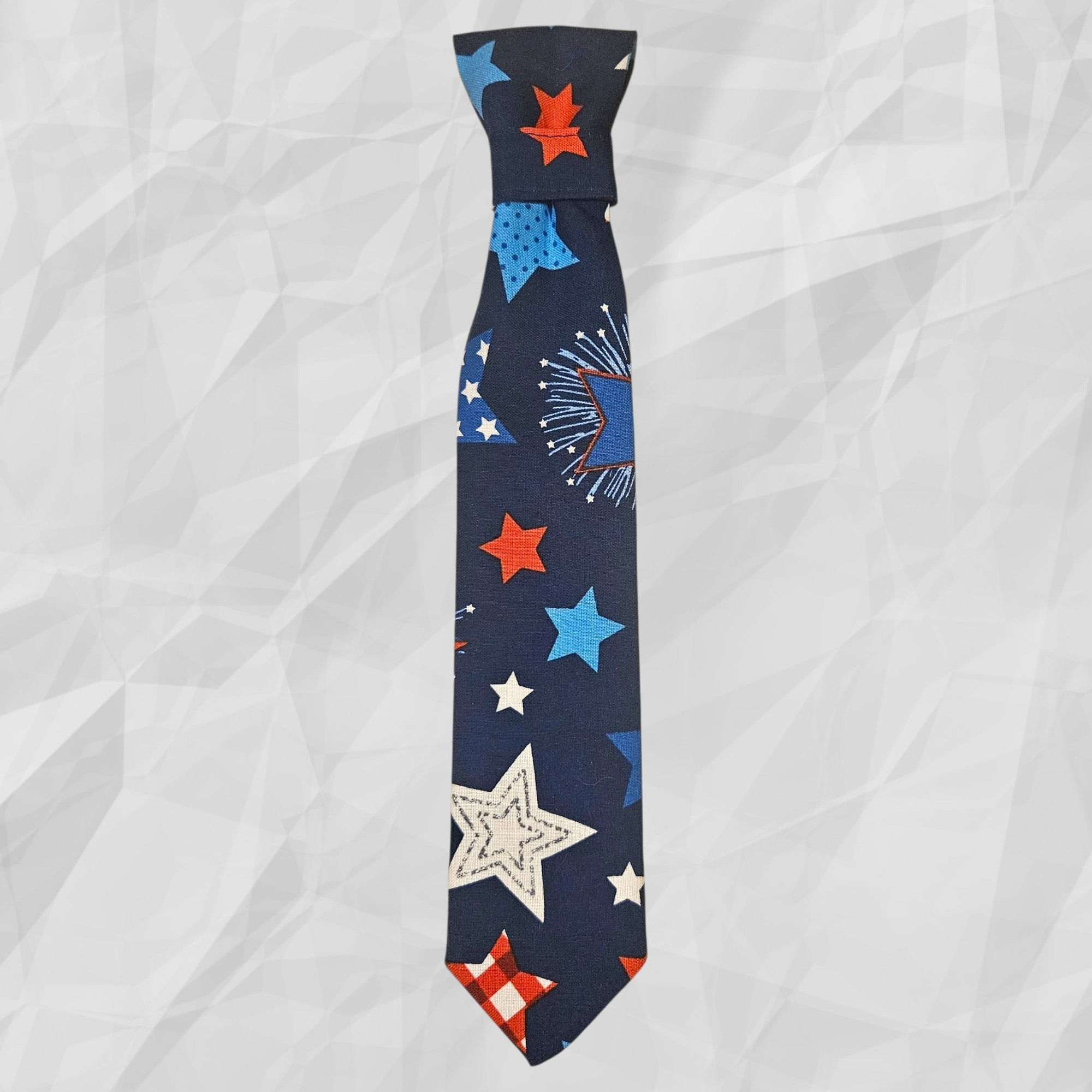 July 4th Patriotic Pet Formal Tie with a print of large stars and fireworks set on a blue background