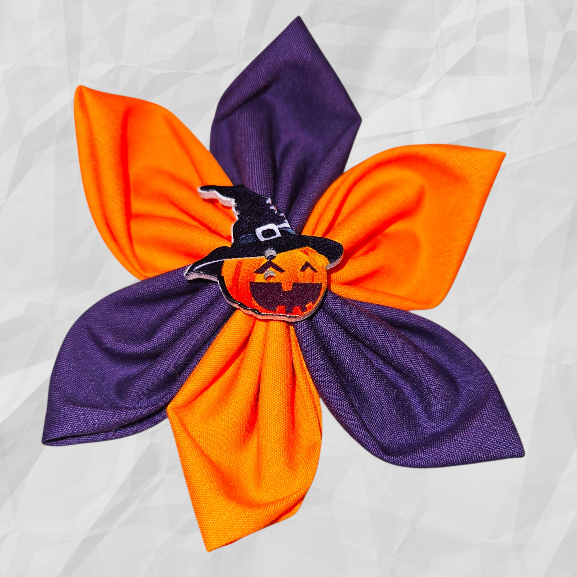 Adorable halloween collar flower with orange and purple feathers and a pumpkin in the center