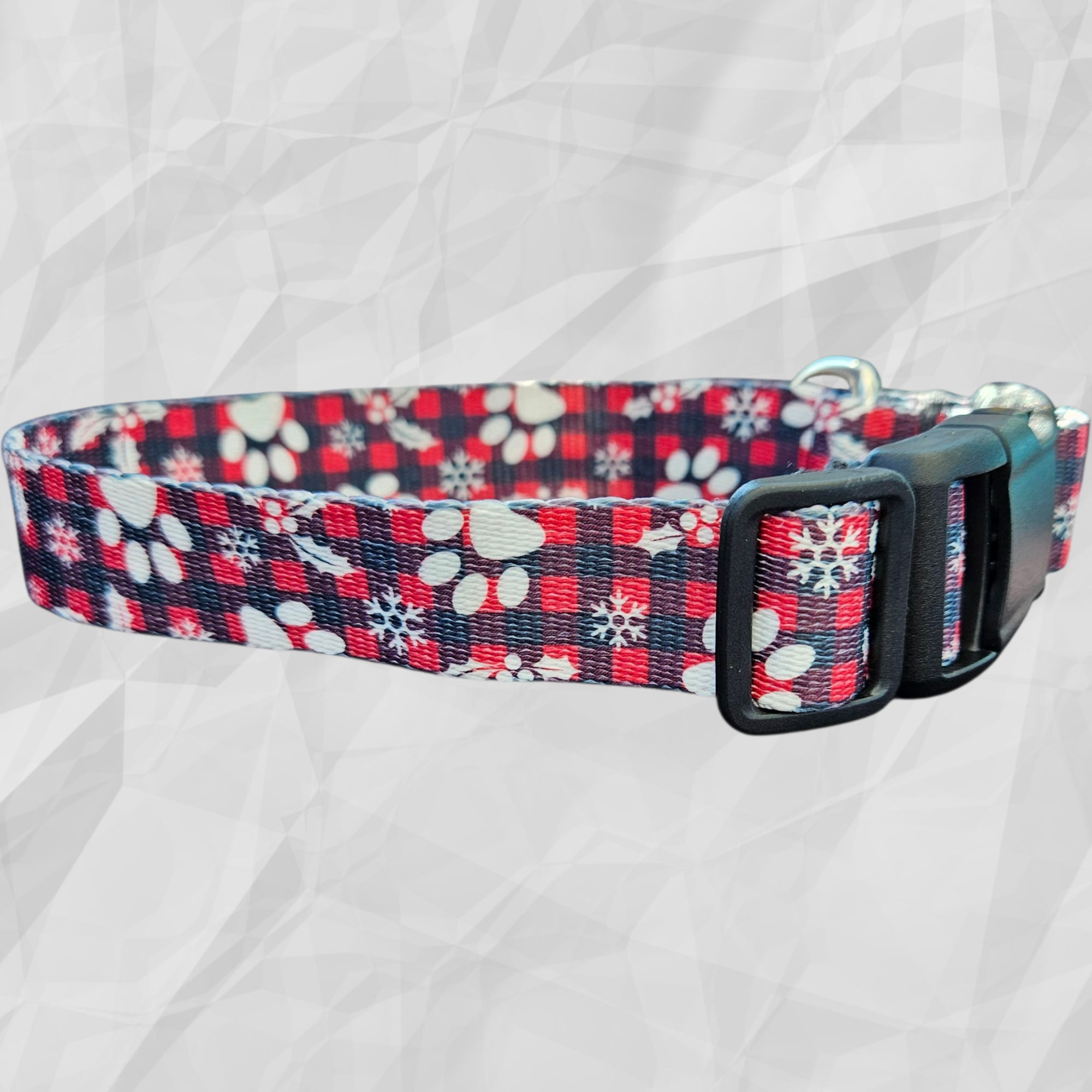 Christmas Winter Season Dog Collar with a red plaid pattern and white paw prints and snowflakes