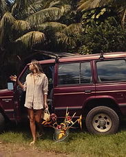 Vitamin A look beside a red Land Rover on a North Shore road, Maui
