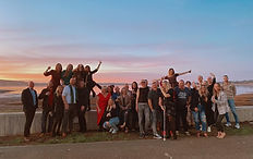 Group photo in front of the sunset view from a recent birthday party