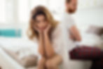 Man and Woman Look Upset While Sitting On Bed.
