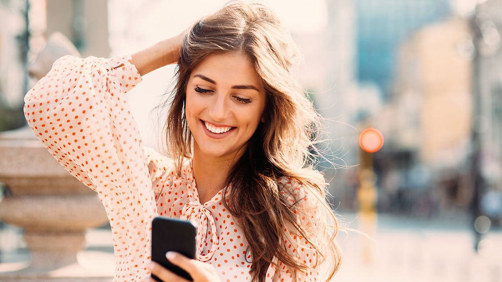 Woman Smiling at Phone With Hand On Her Head