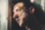 A person gazes thoughtfully out of a window