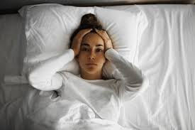 Woman in Bed Tired Upset