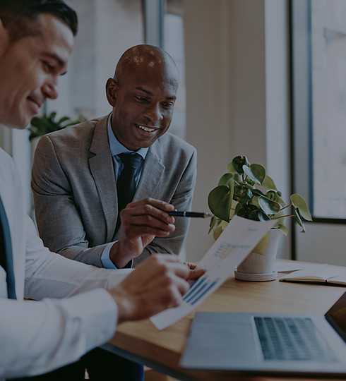two-diverse-businessmen-going-over-graph
