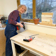 Deborah making her work benches in her studio