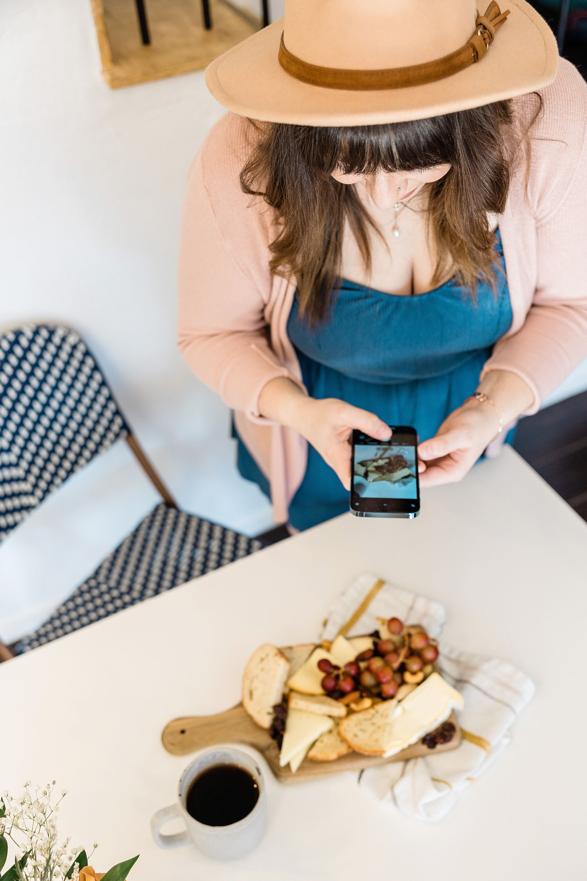 Woman taking a photo with her phone of some food for her food blog