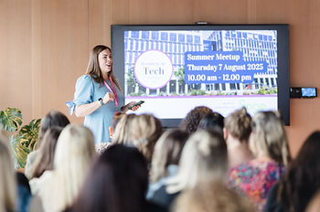 kathryn wharton stood in front of a room of women presenting
