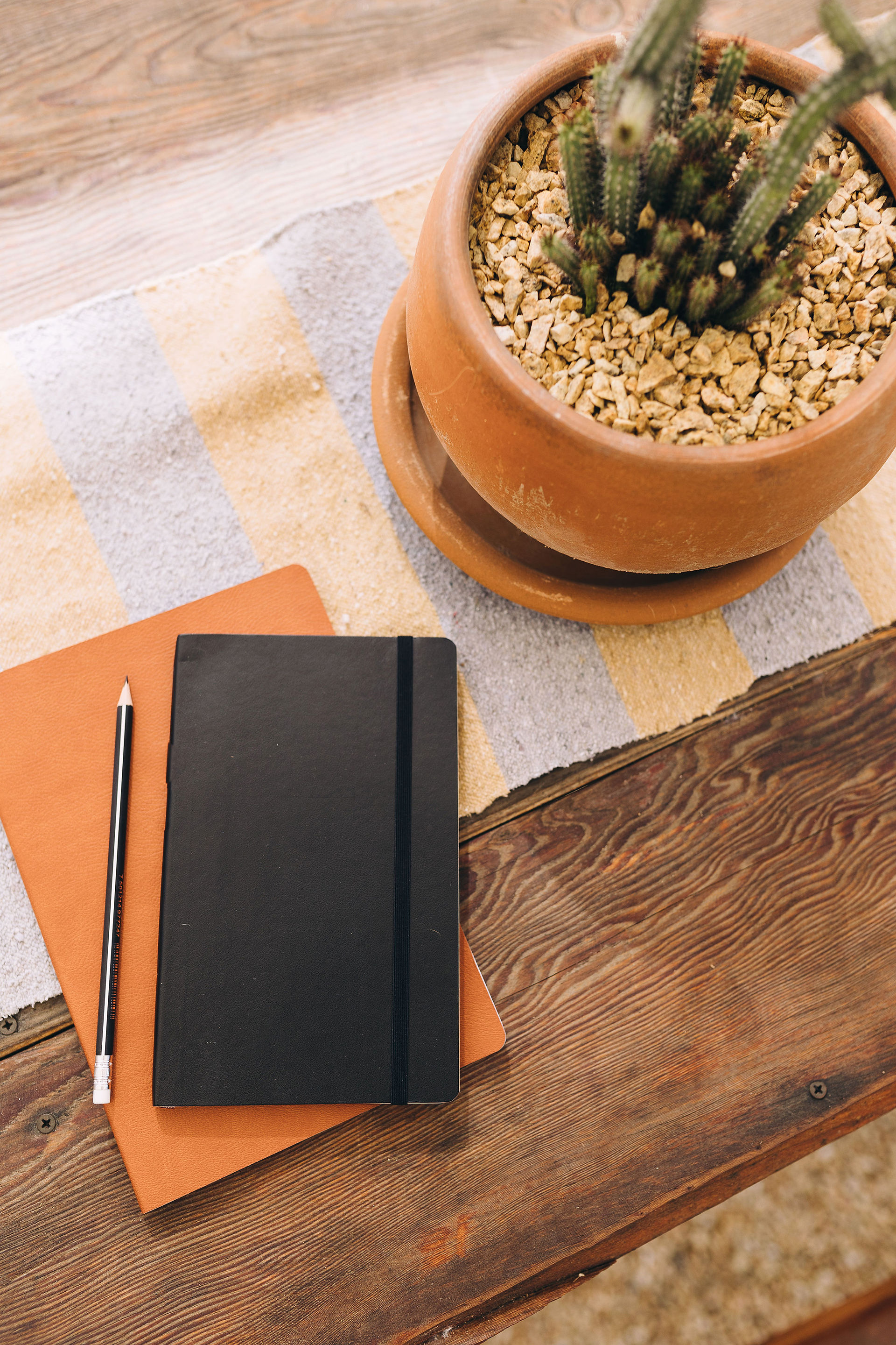Note pads and pencil on a bench