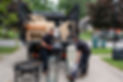 Two guys removing junk from a home and loading a truck.