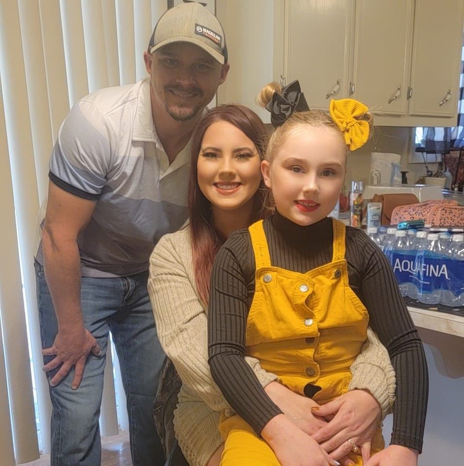 Family portrait with a father, mother, and daughter.