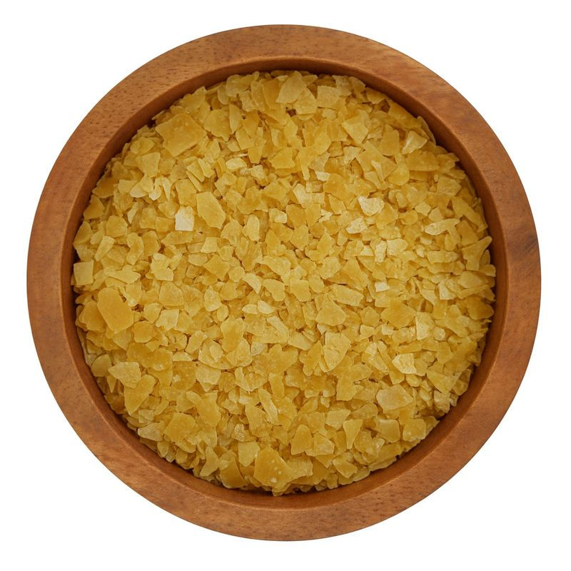 T3 carnauba wax flakes in wooden bowl
