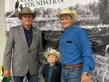 FCA President Rick Moyer standing with a FCA member and his son.