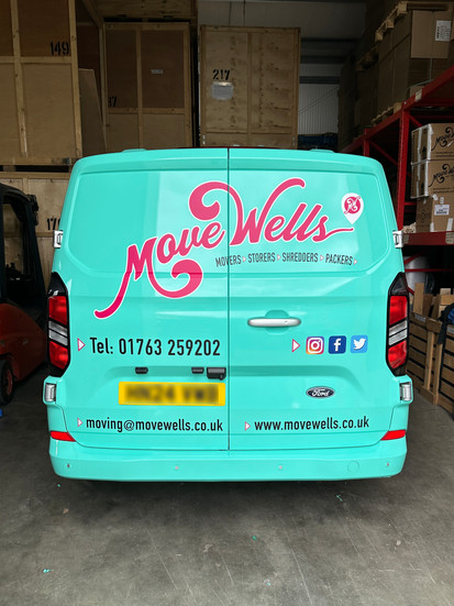 Rear view of Move Wells van with custom vehicle graphics, contact details and branding designed for high visibility advertising