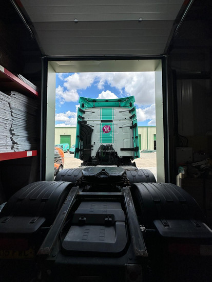 View from inside trailer looking onto back of Move Wells truck with custom vinyl graphics applied.