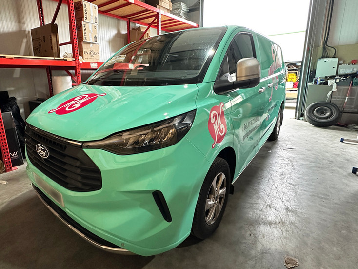 Close-up of Move Wells branded van wrap showing high-quality vinyl graphics applied to commercial vehicle for brand visibility