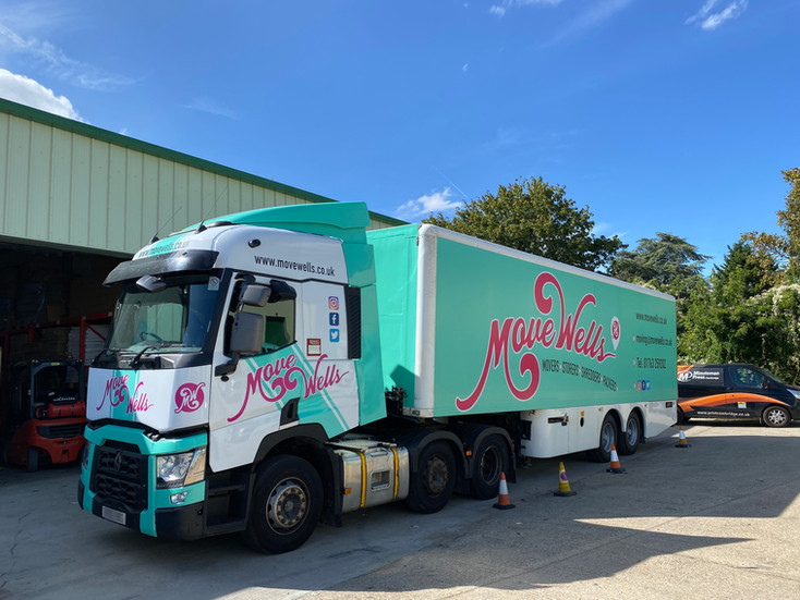 Branded articulated lorry and trailer with custom vinyl vehicle graphics for Move Wells, showcasing large-scale fleet branding and mobile advertising