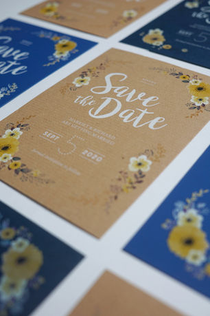 Save the Date invite design printed using white ink on a range of Kraft and blue paper stocks.
