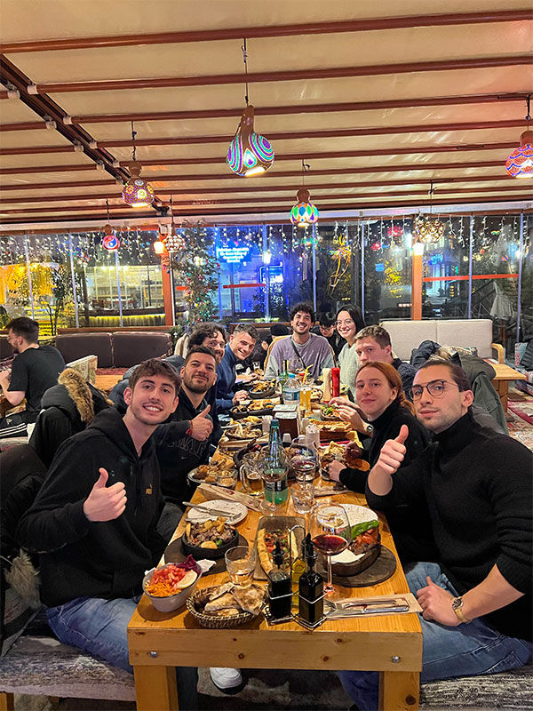Friends sharing a lively dinner together at Palatium Cafe and Restaurant