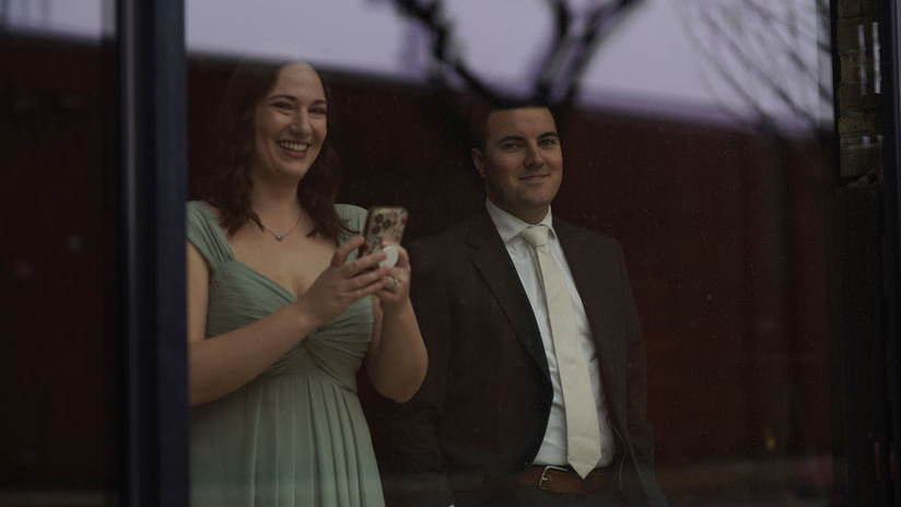 Family looking through a window on a wedding day.