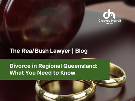 Close-up of a judge's gavel and two gold wedding rings, with blog title "Divorce in Regional Queensland: What You Need to Know" by Creevey Horrell Lawyers, part of "The Real Bush Lawyer" blog series.