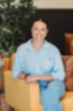 brown haired female accountant yellow chair jeans
