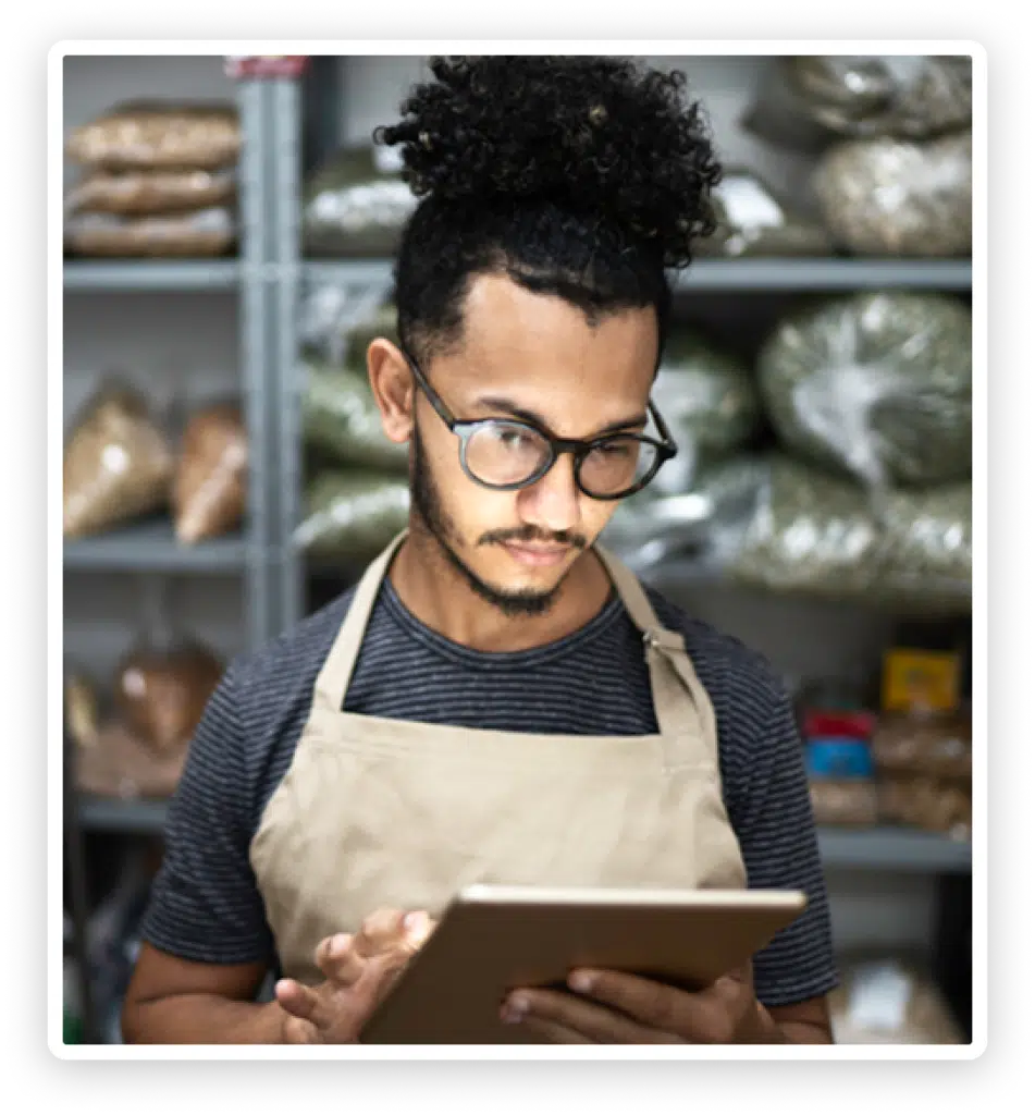 Man Wearing Apron Kitchen Using Tablet - OneJar is an HR boutique firm delivering world-class solutions.