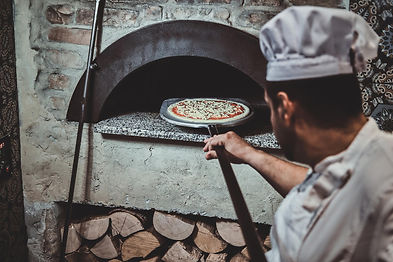 experienced-chef-is-putting-his-pizza-oven-using-special-giant-spatula.jpg