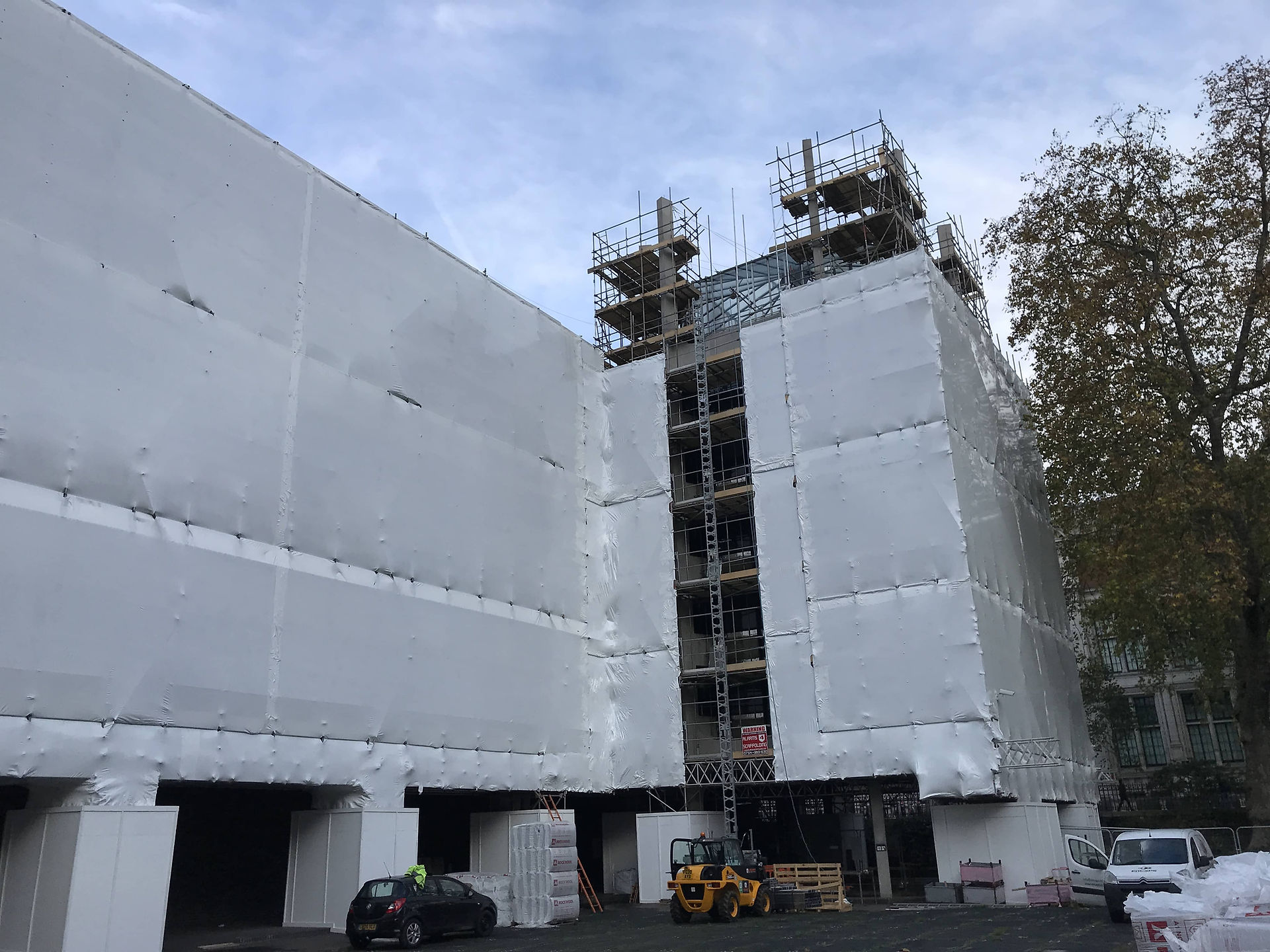 Full scaffold encapsulation in shrink wrap on a London building.