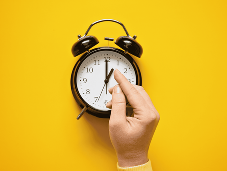 finger pointing a clock