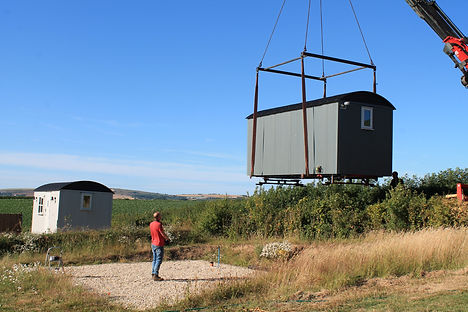 Shepherds hut being delivered using a crane lorry