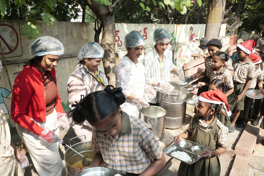 Inorbit Malls employees serving meals to children at Christmas celebration with Akshaya Patra Foundation at Sivajipalem School Visakhapatnam