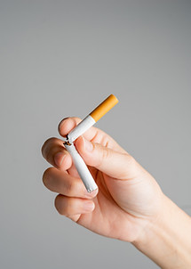 Stop smoking, quit smoking or no smoking cigarettes. Woman holding broken cigarette in han
