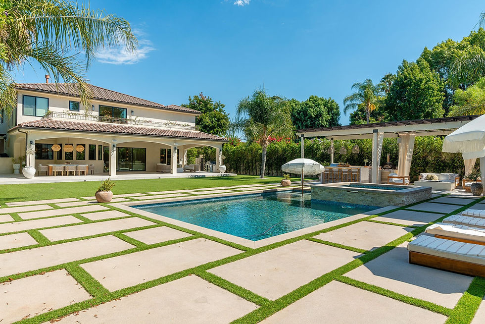 Eye-level view of a backyard with a newly constructed swimming pool surrounded by landscaping