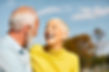 happy-couple-standing-against-sky.jpg