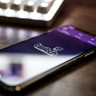 cellphone on table with twitch content, fashion gaming, digital gaming, digital fashion