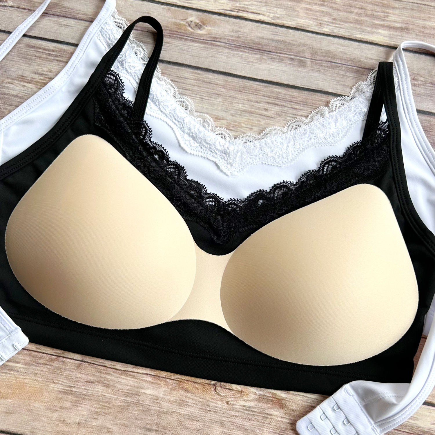 the busted tank lace clasp plunge pocketed mastectomy bras white and black shown with breast forms