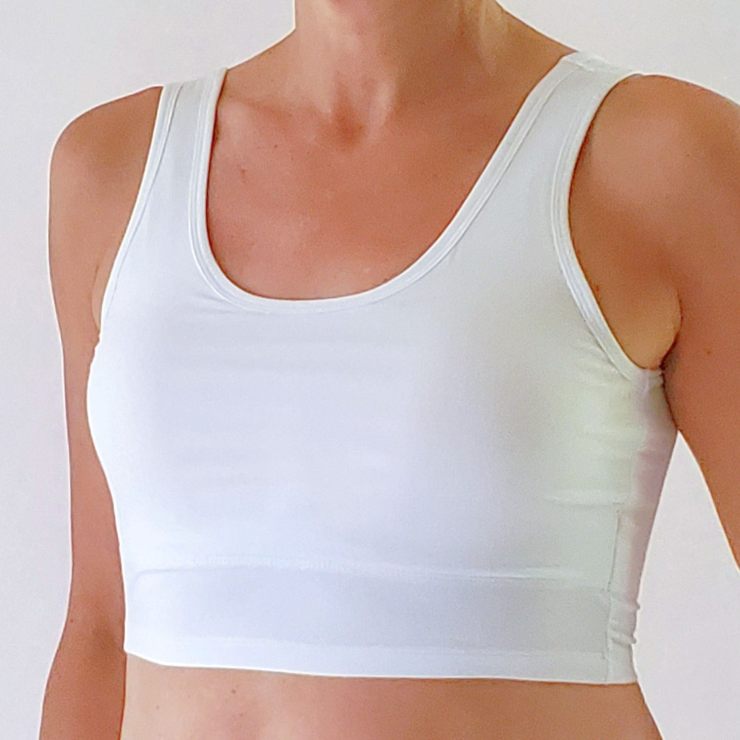 the busted tank modal cami pocketed mastectomy bra white with breast forms inserted
