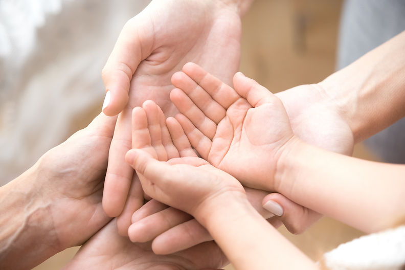 Close up of three caucasian person stack their palms. Grandmother mother and granddaughter