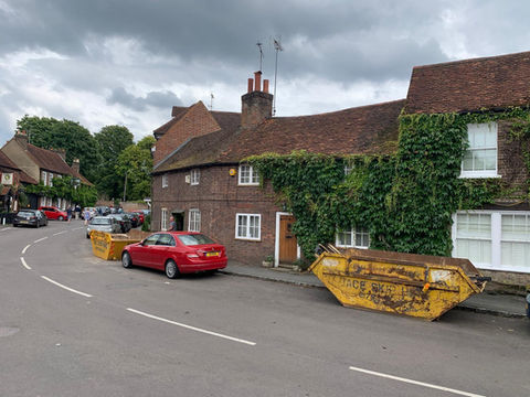 Skip parked on road
