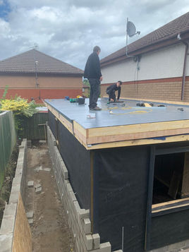 Roofers installing flat roof